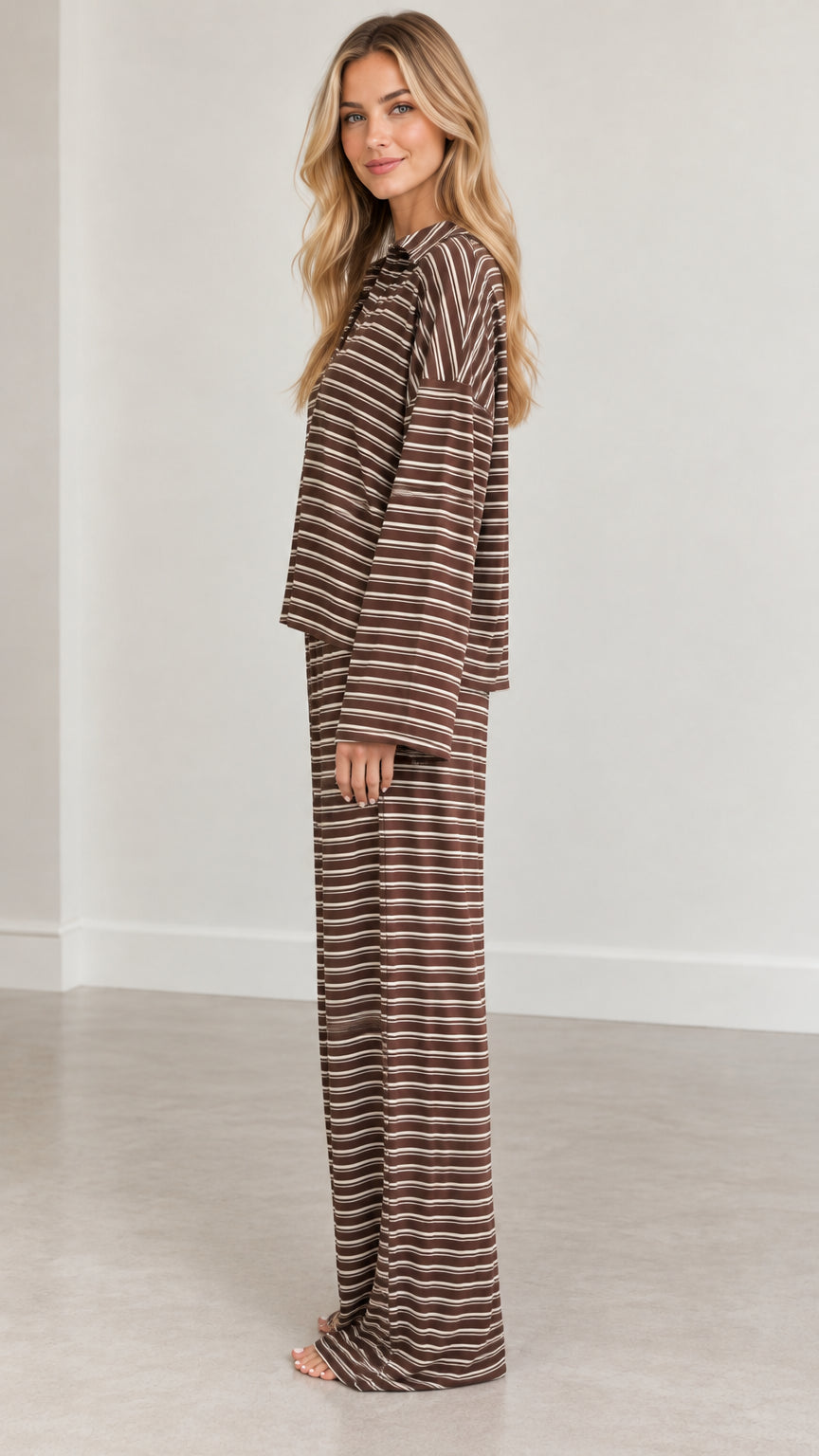 Side profile view of woman wearing brown striped two-piece loungewear set