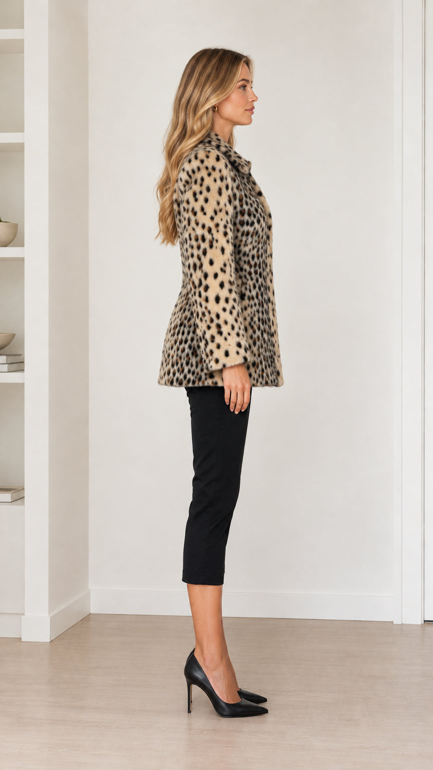 Side profile of model wearing camel leopard print coat showcasing tailored fit and mid-length hem