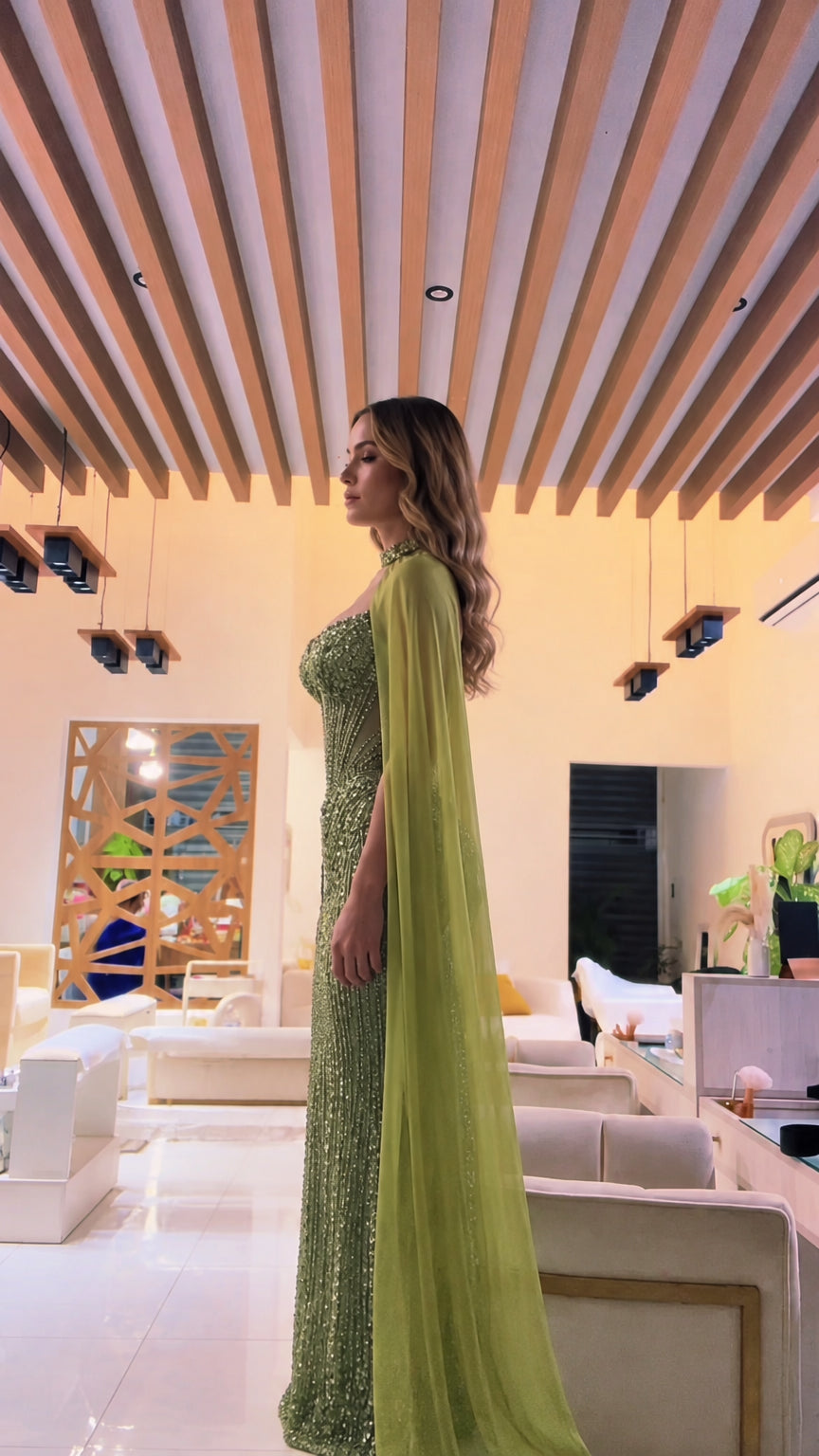 Olive green sequined formal maxi gown with flowing floor-length sheer cape side view