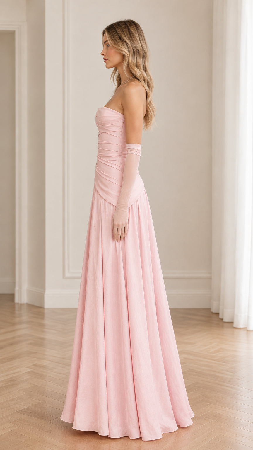 Side profile of blush pink strapless formal maxi gown