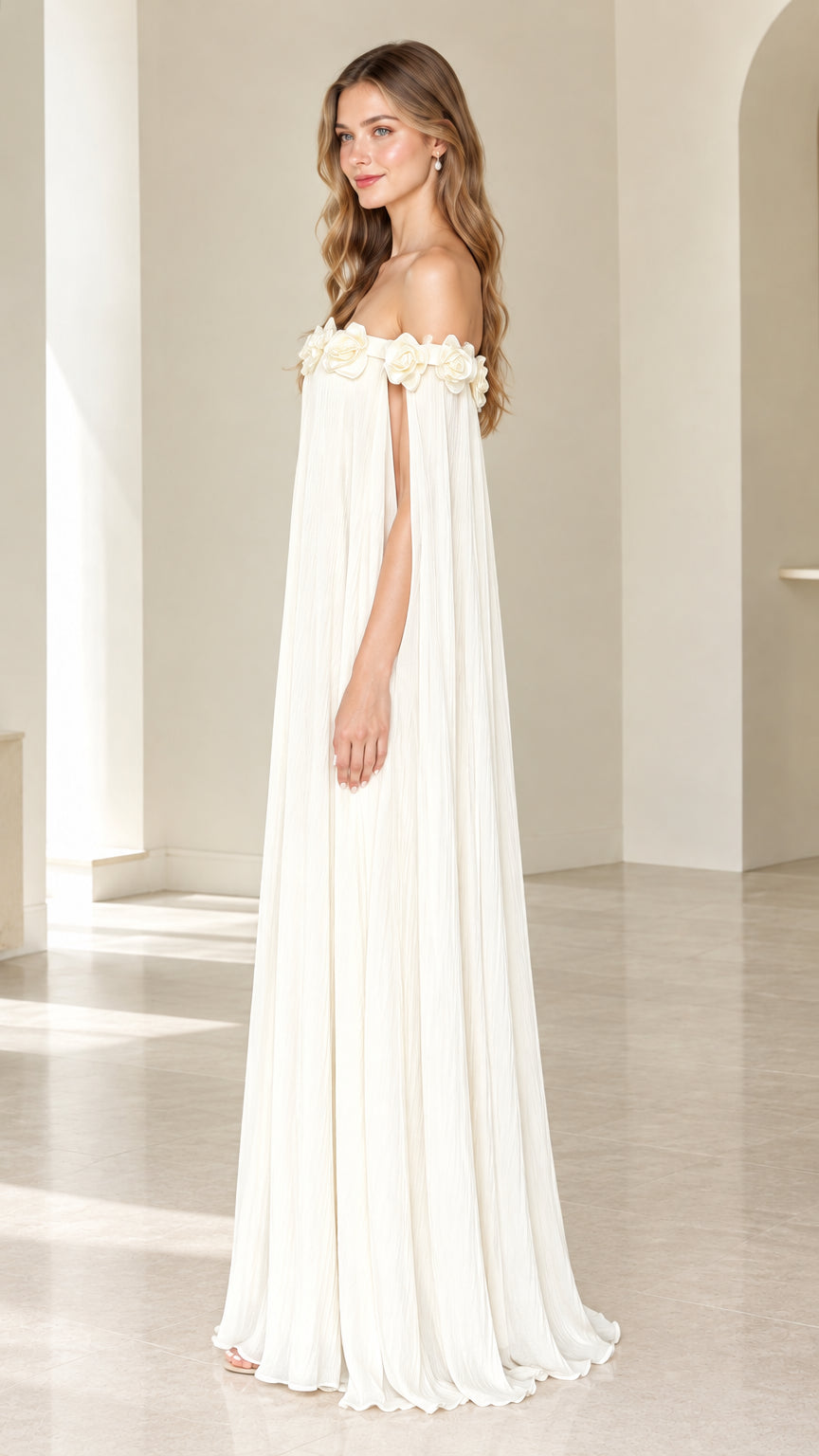 Side angle of model in Ivory flowing pleated cape sleeve maxi gown