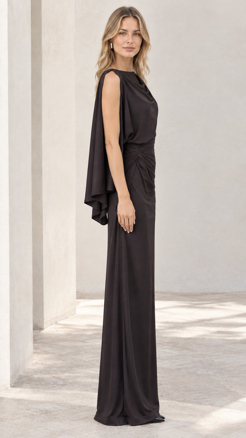 Side profile of black one-shoulder cape sleeve formal gown