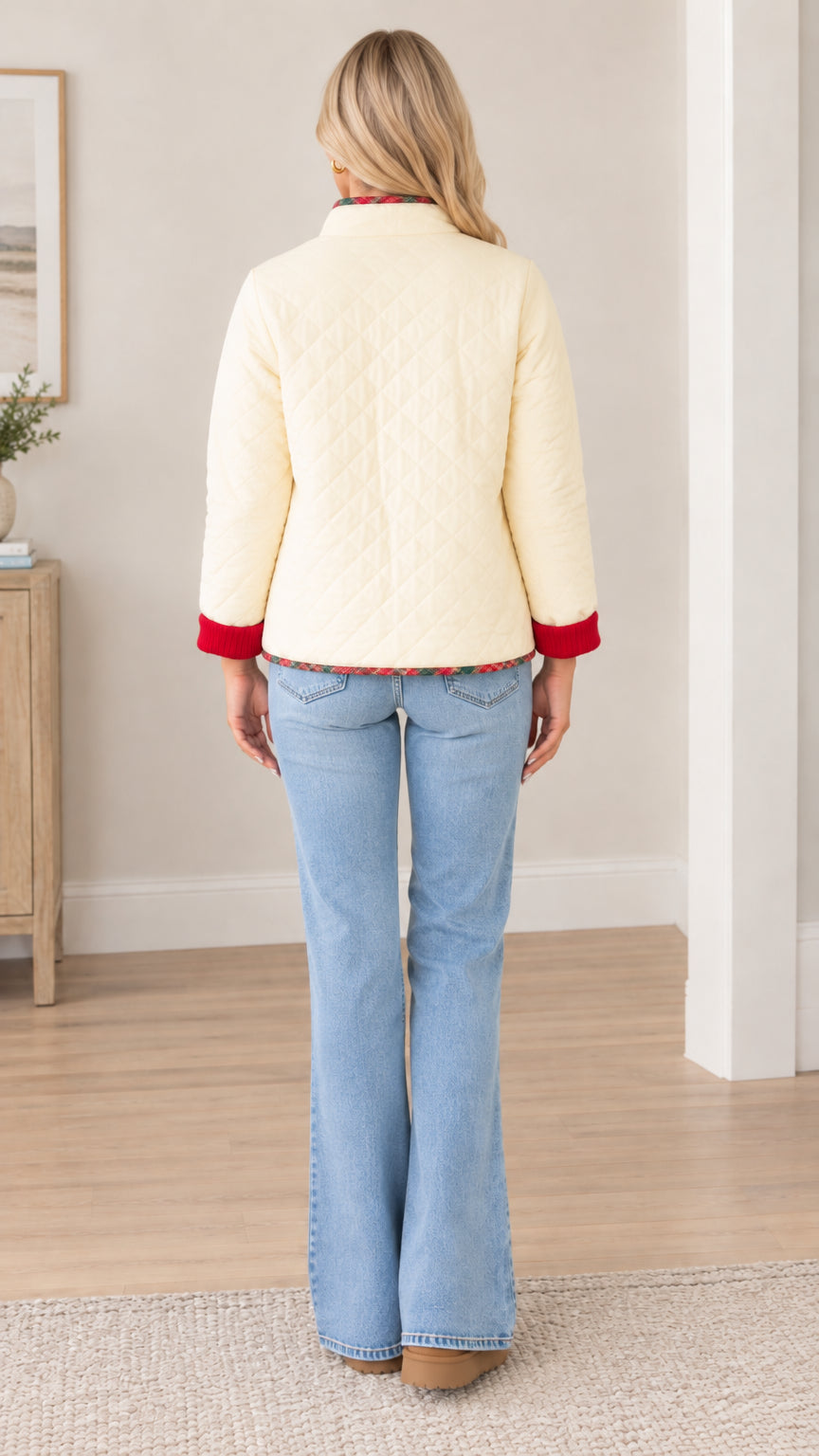 Back view of cream quilted jacket showing diamond stitch pattern and ribbed cuffs