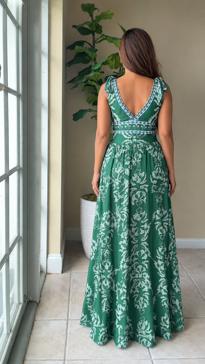Back view showing deep V-back design of emerald green floral maxi dress