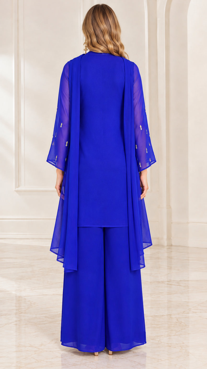 Back full-length view of royal blue tunic and wide-leg trousers with draped scarf details