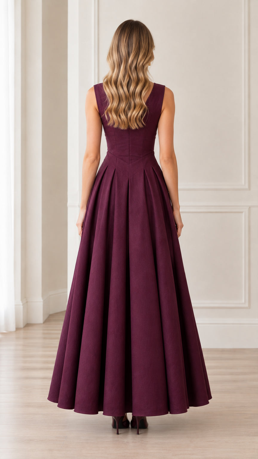 Back view of woman wearing sleeveless burgundy maxi dress with tailored bodice