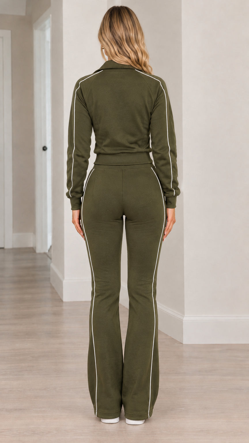 Back view of woman wearing olive green 2-piece tracksuit set with piping details