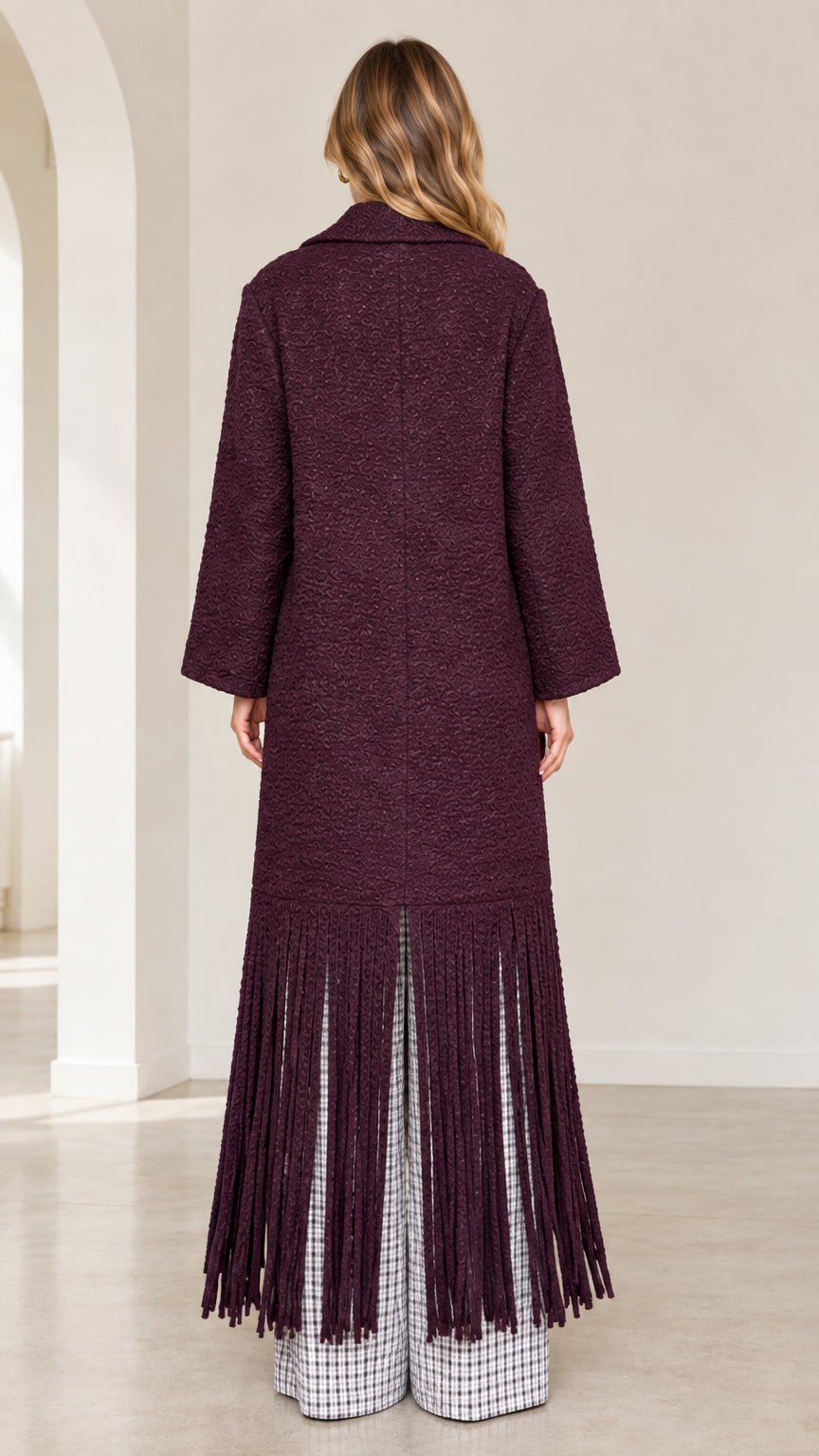 Back view of model wearing burgundy fringe hem bouclé maxi coat