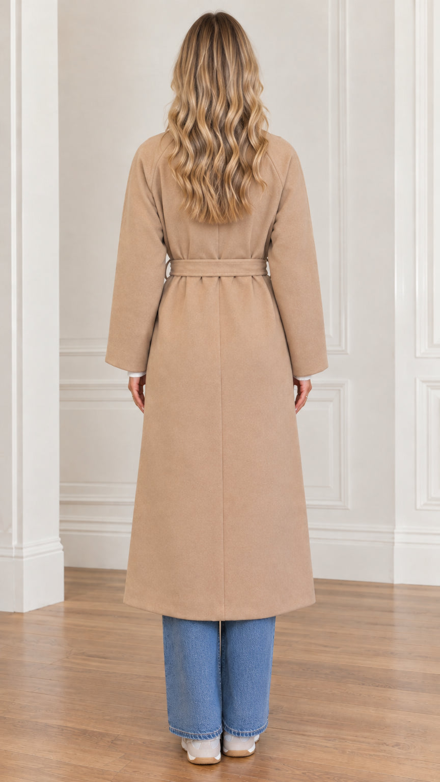 Back view of woman wearing long camel belted overcoat
