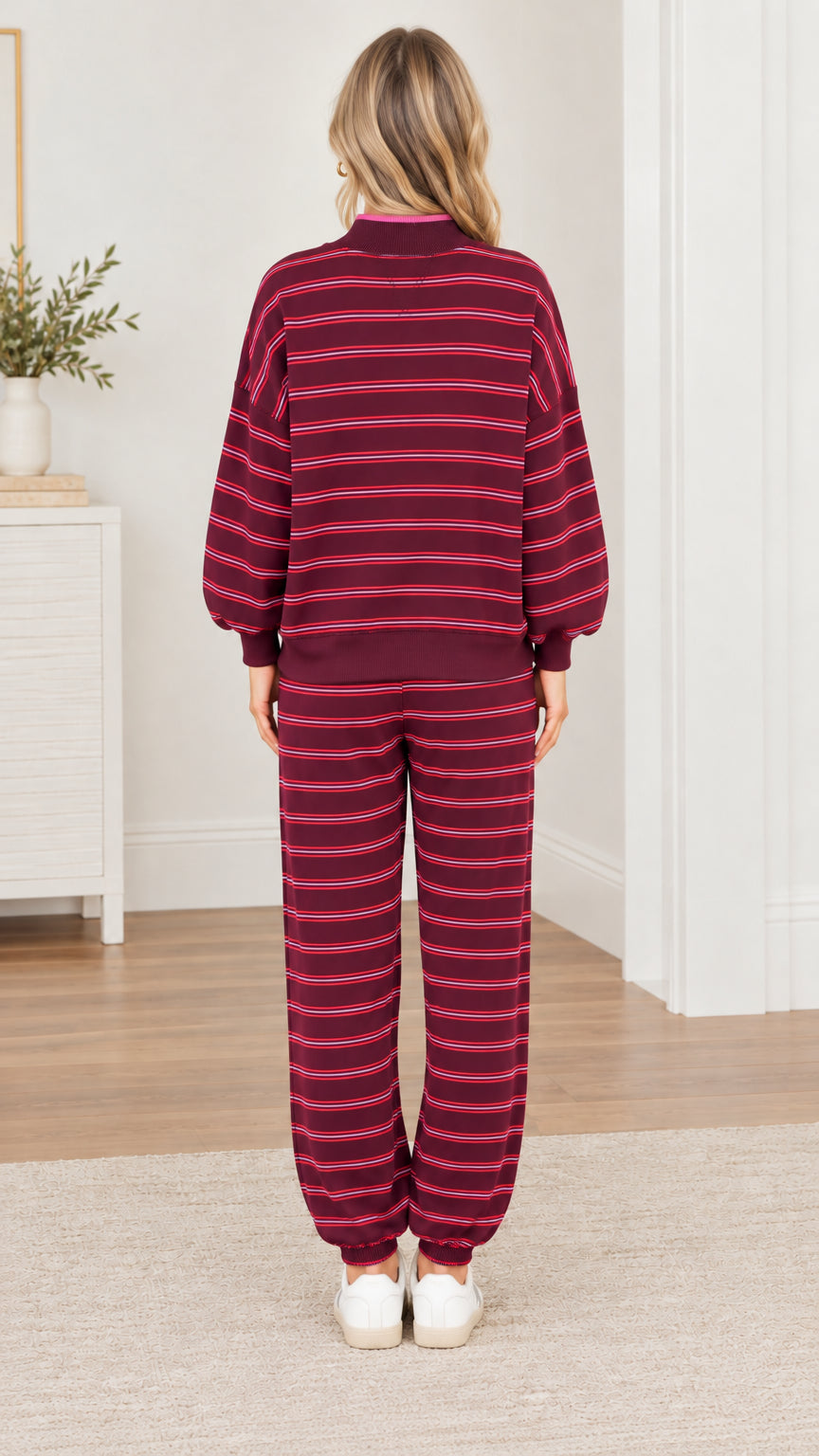 Back view of woman wearing burgundy striped sweatshirt and jogger pants set
