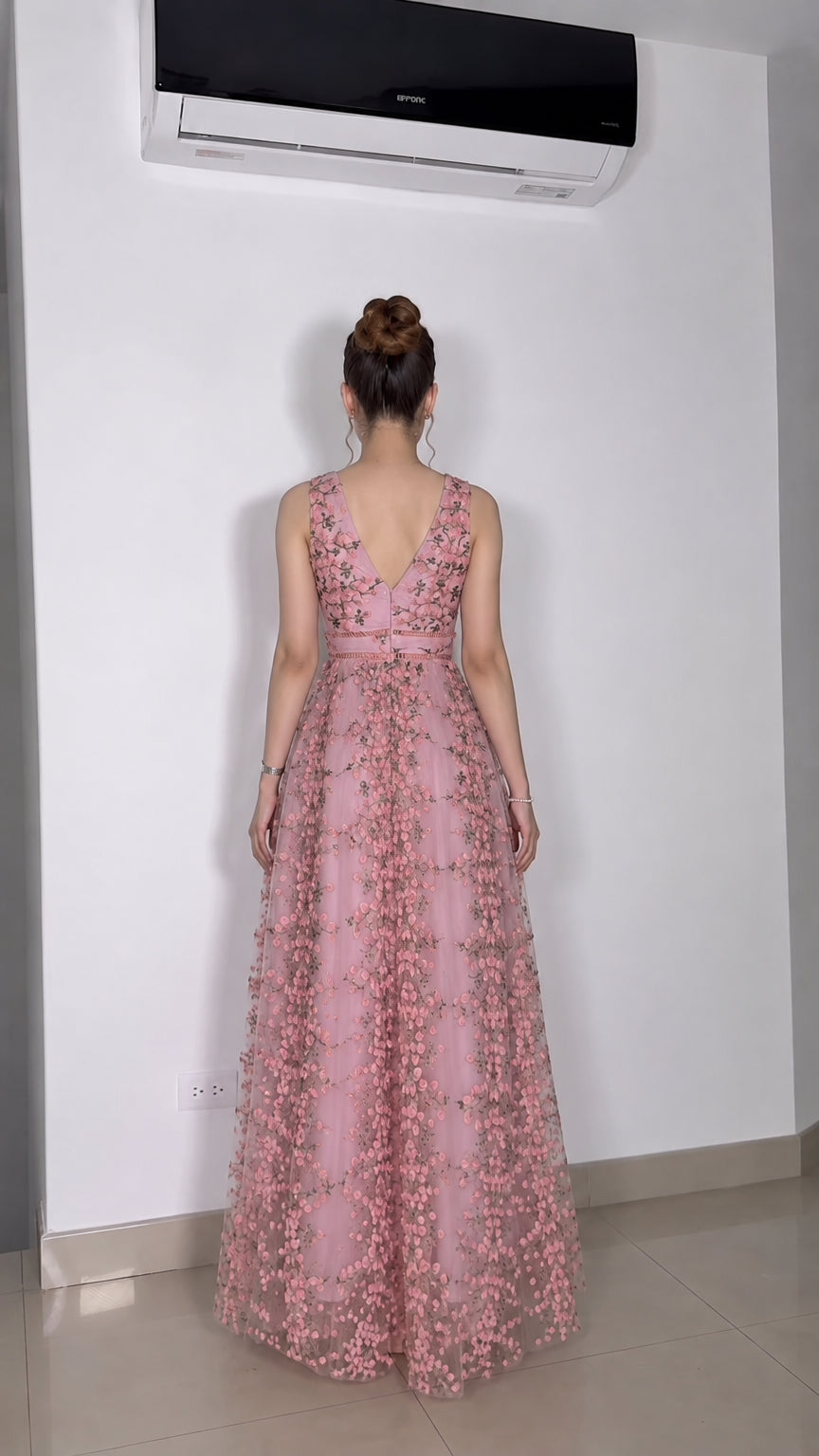 Back view of model wearing pink floral tulle dress with V-back
