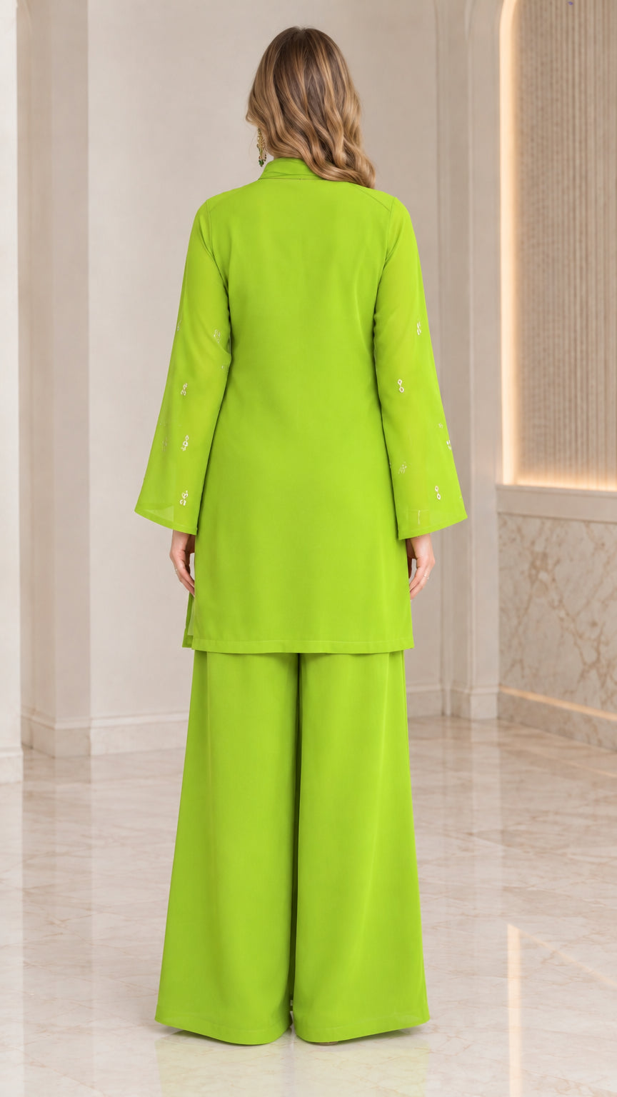 Back full-length view of model in lime green co-ord set showing relaxed tunic and pant fit