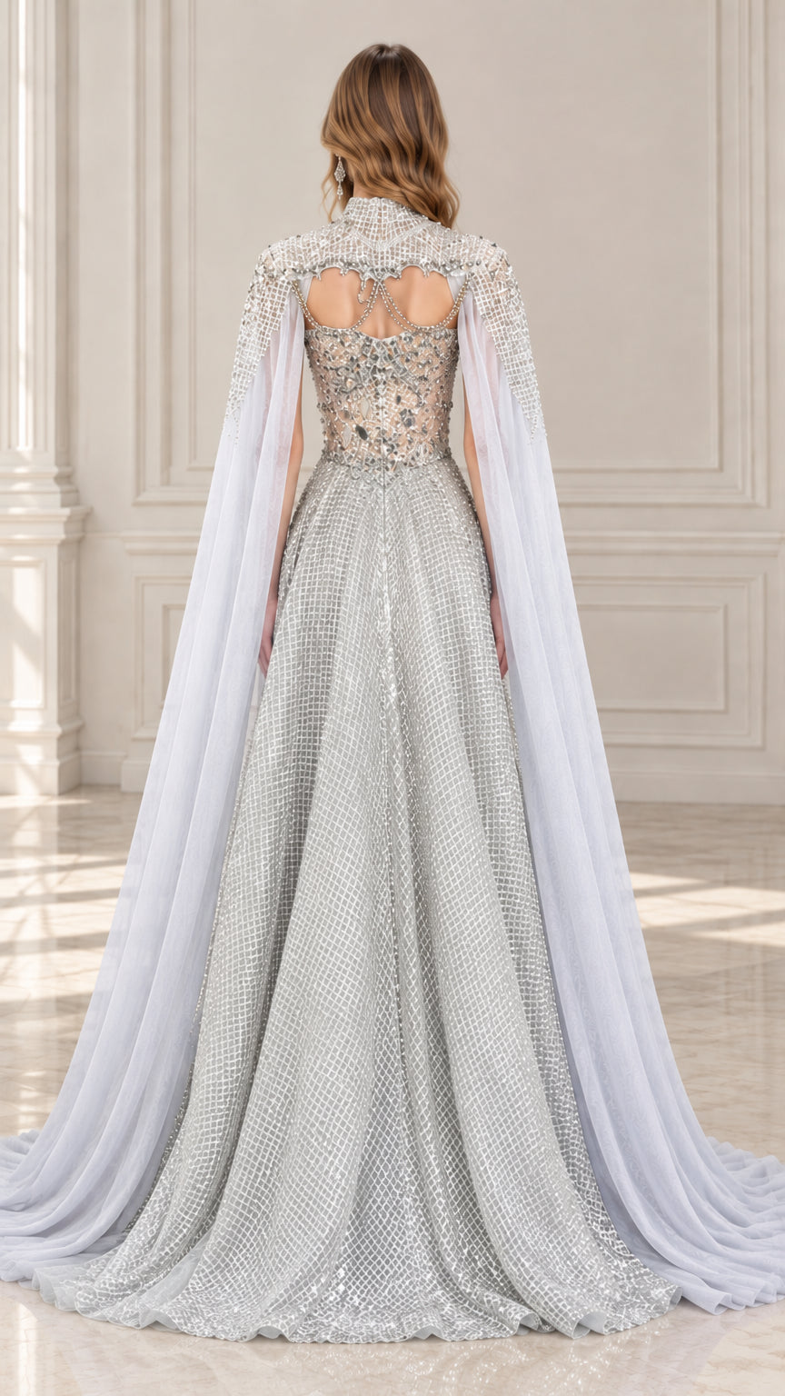 Back view of model wearing silver gray embellished cape gown with cut-out detail