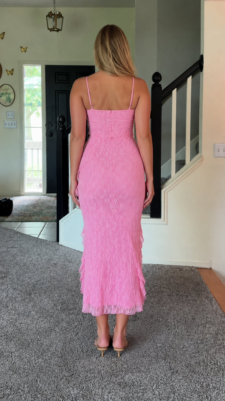 Back view of woman wearing pink lace midi dress with spaghetti straps