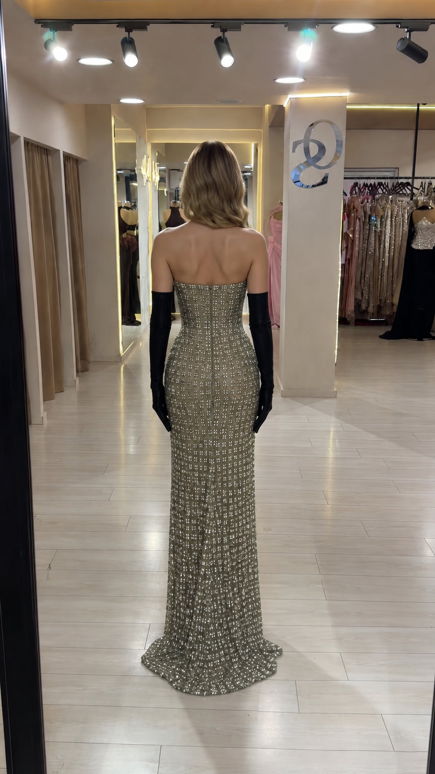 Back view of champagne strapless rhinestone column evening gown