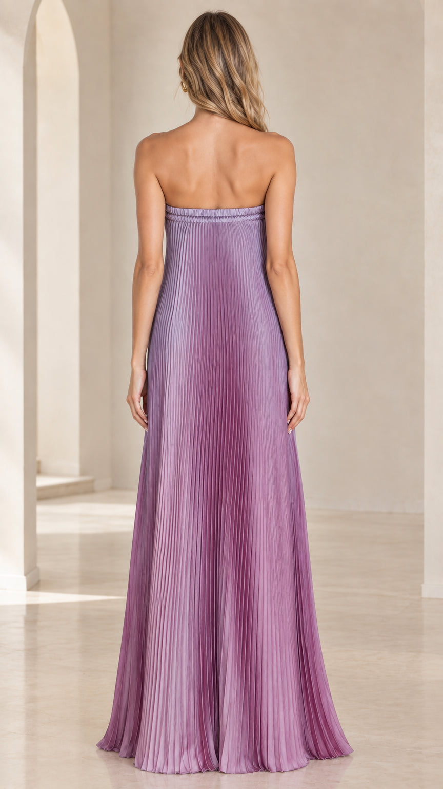 Back view of model wearing purple ombre strapless pleated maxi dress
