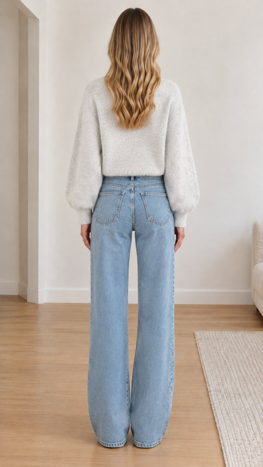 Back view of model wearing light grey fuzzy button-up cardigan sweater