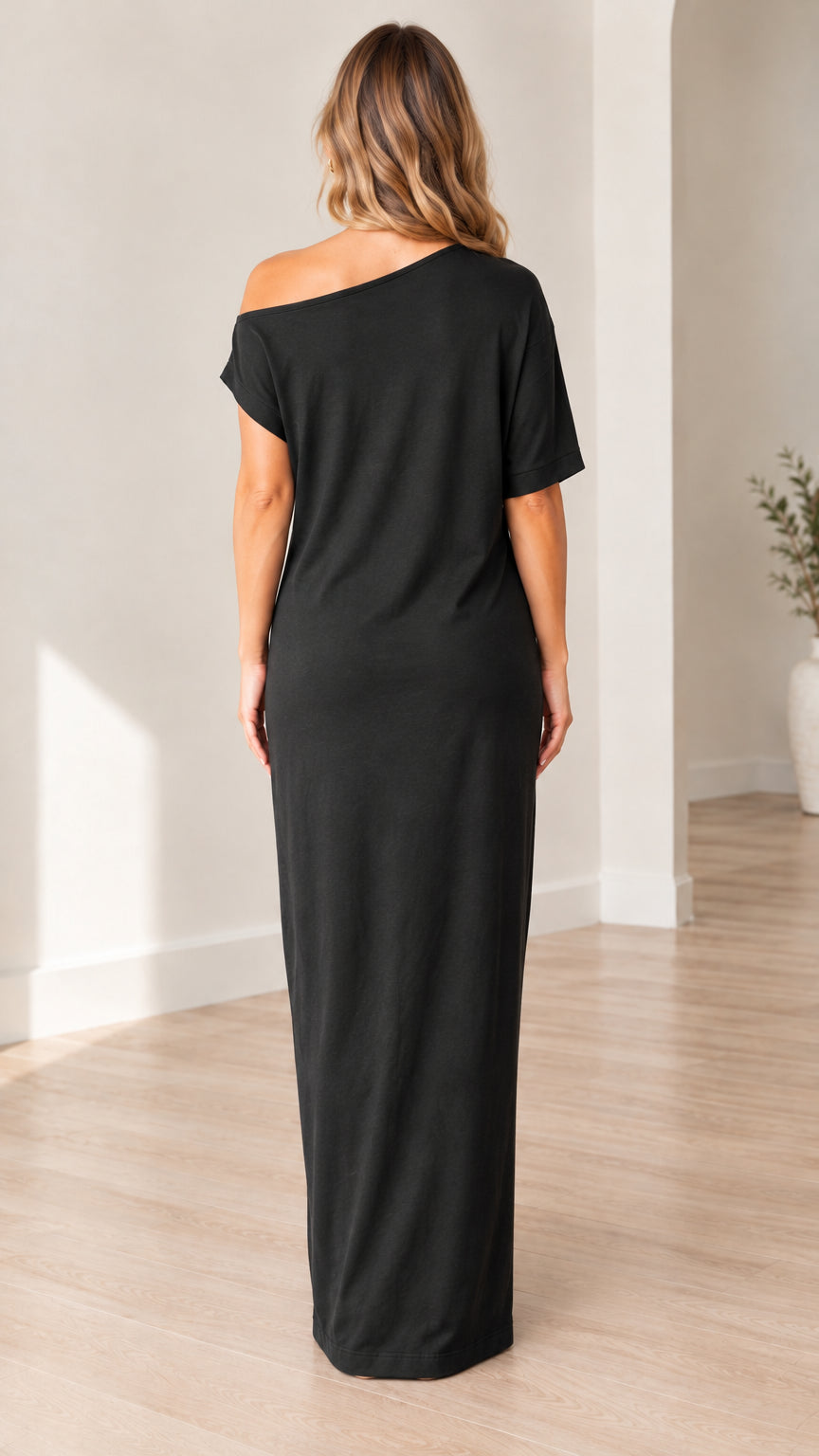 Back full-length view of woman in black short sleeve maxi dress