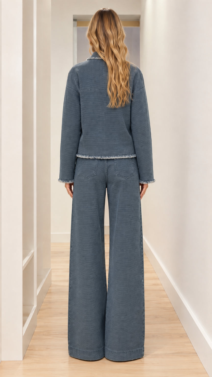 Back full-length view of woman modeling slate blue two-piece frayed trim trouser set