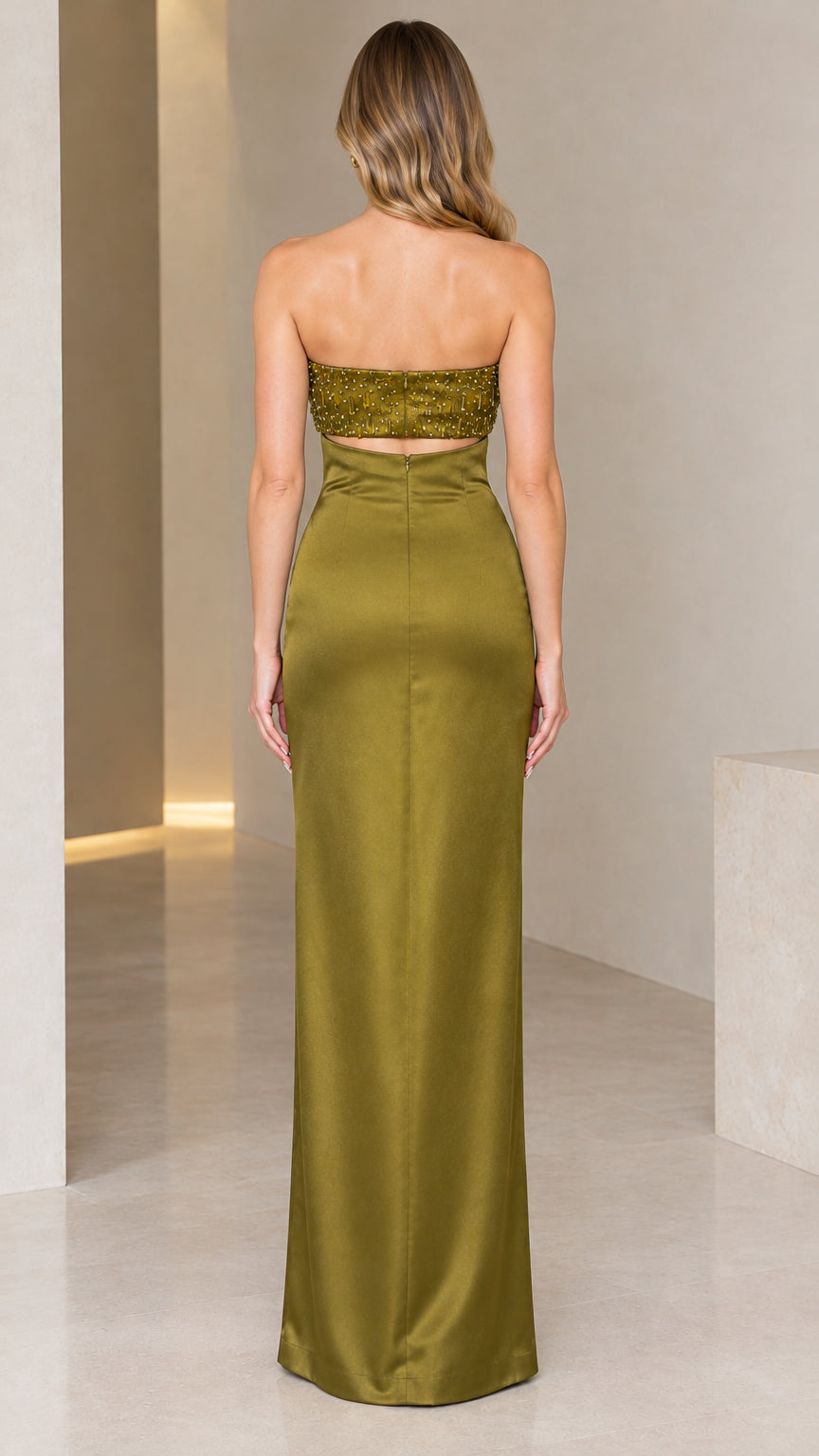 Back view of model in olive green strapless evening gown showing zipper closure