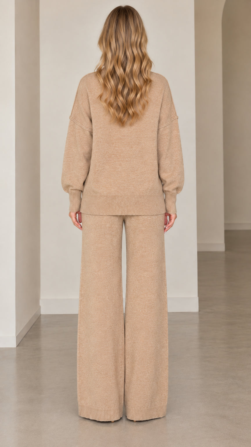 Back full-length view of model wearing beige relaxed knit sweater and wide-leg lounge pants