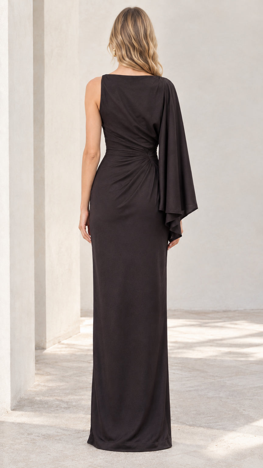 Back view of black one-shoulder cape sleeve ruched maxi dress