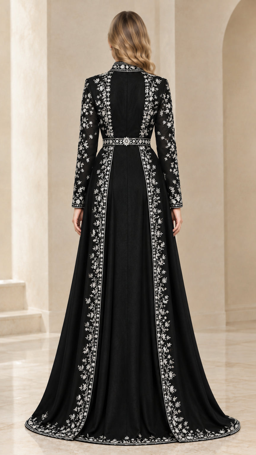 Back view of black formal evening coat showing ornate floral embroidery along the hem and collar