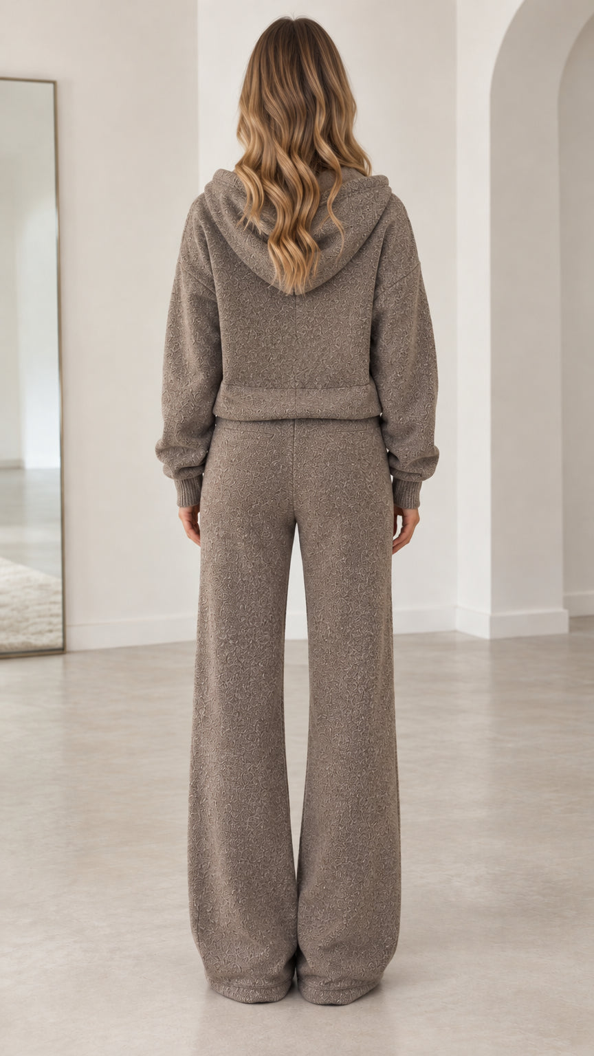 Back view of model wearing taupe textured knit hoodie and wide-leg pants set