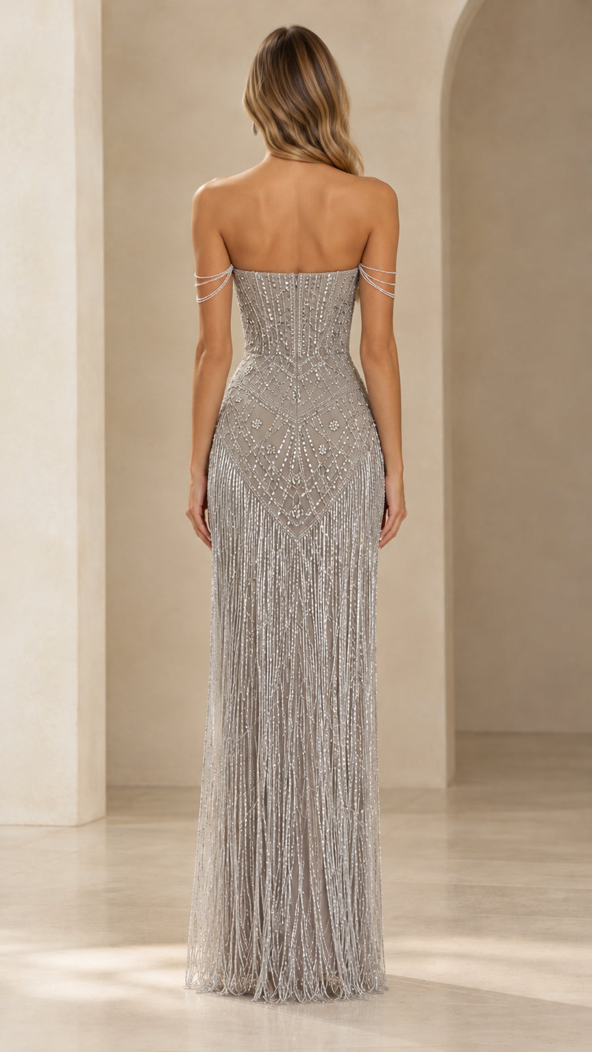 Back view of model in a silver beaded maxi gown showing sleek column fit