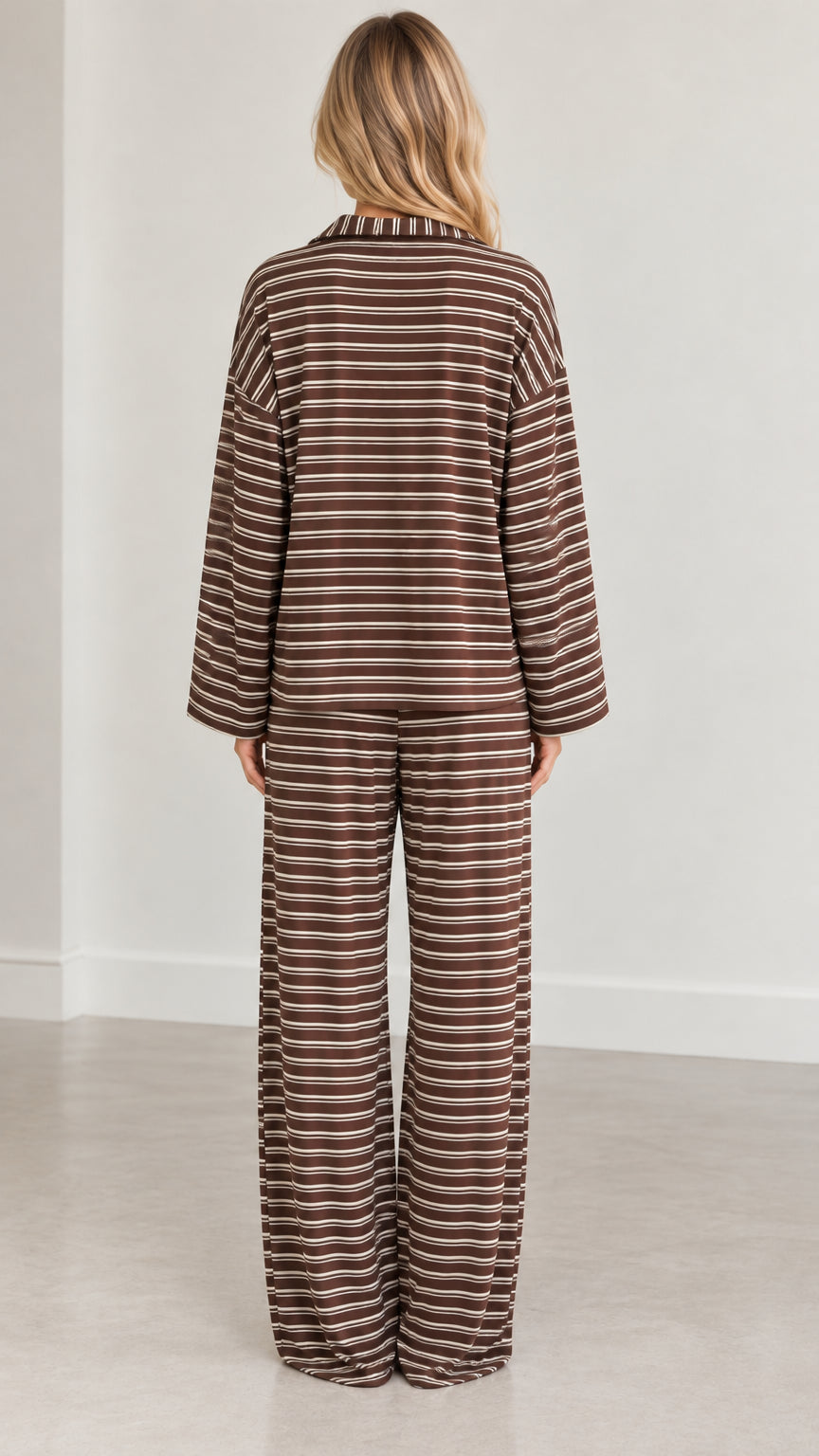 Back full-length view of woman wearing brown striped loungewear set