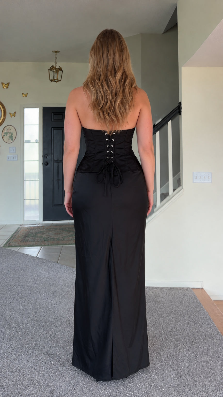 Back view of black halter top and lace-up corset waistband maxi skirt with slit