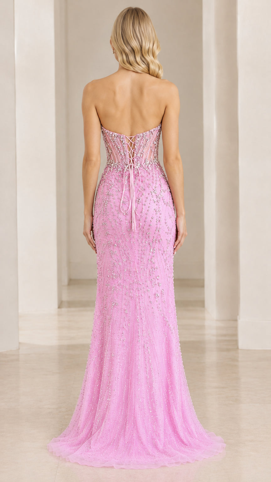 Back view of pink strapless corset gown showcasing lace-up tie closure
