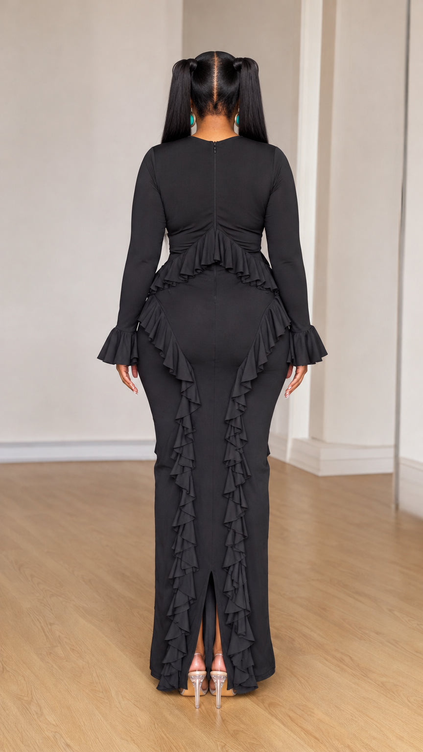 Back view of black long sleeve maxi dress showing rear ruffle detailing and center split