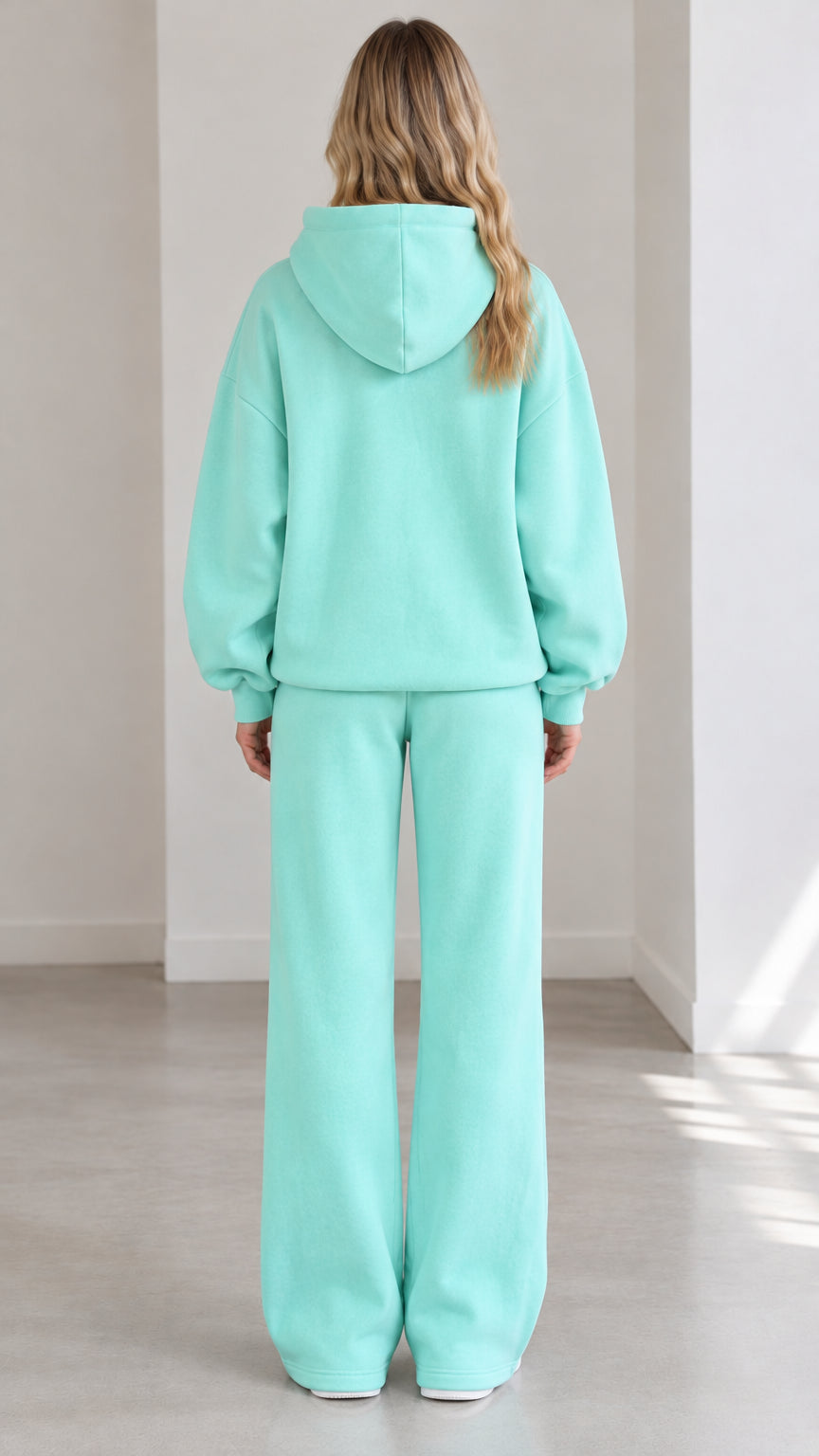 Back view of woman wearing Mint Green fleece hoodie and wide-leg lounge pants