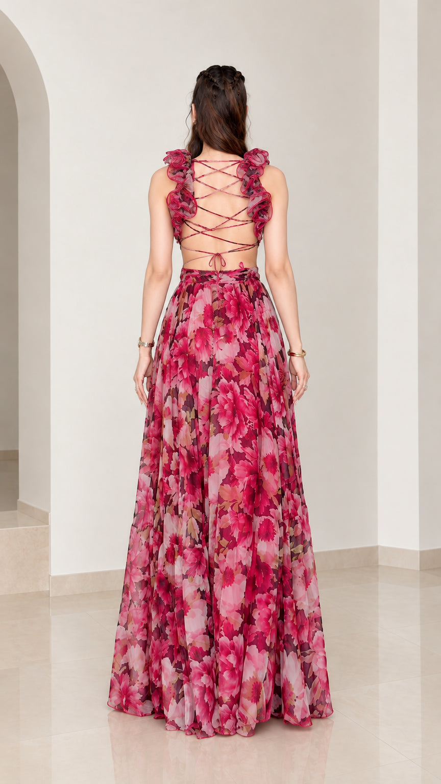 Back view of woman showing criss-cross lace-up tie back and ruffled straps on magenta floral dress