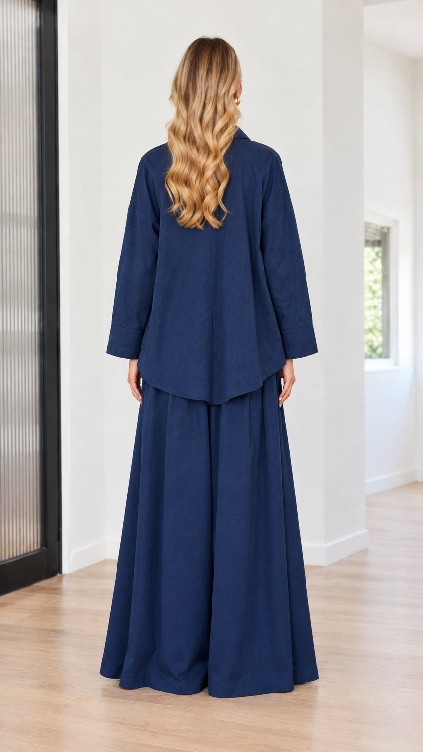 Back view of navy blue two-piece collared shirt and wide-leg trousers outfit