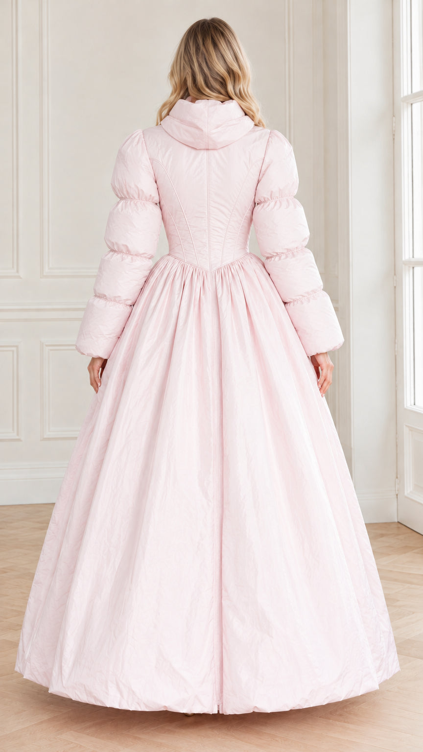 Rear view of model showing the back silhouette and gathered waist of the light pink maxi coat