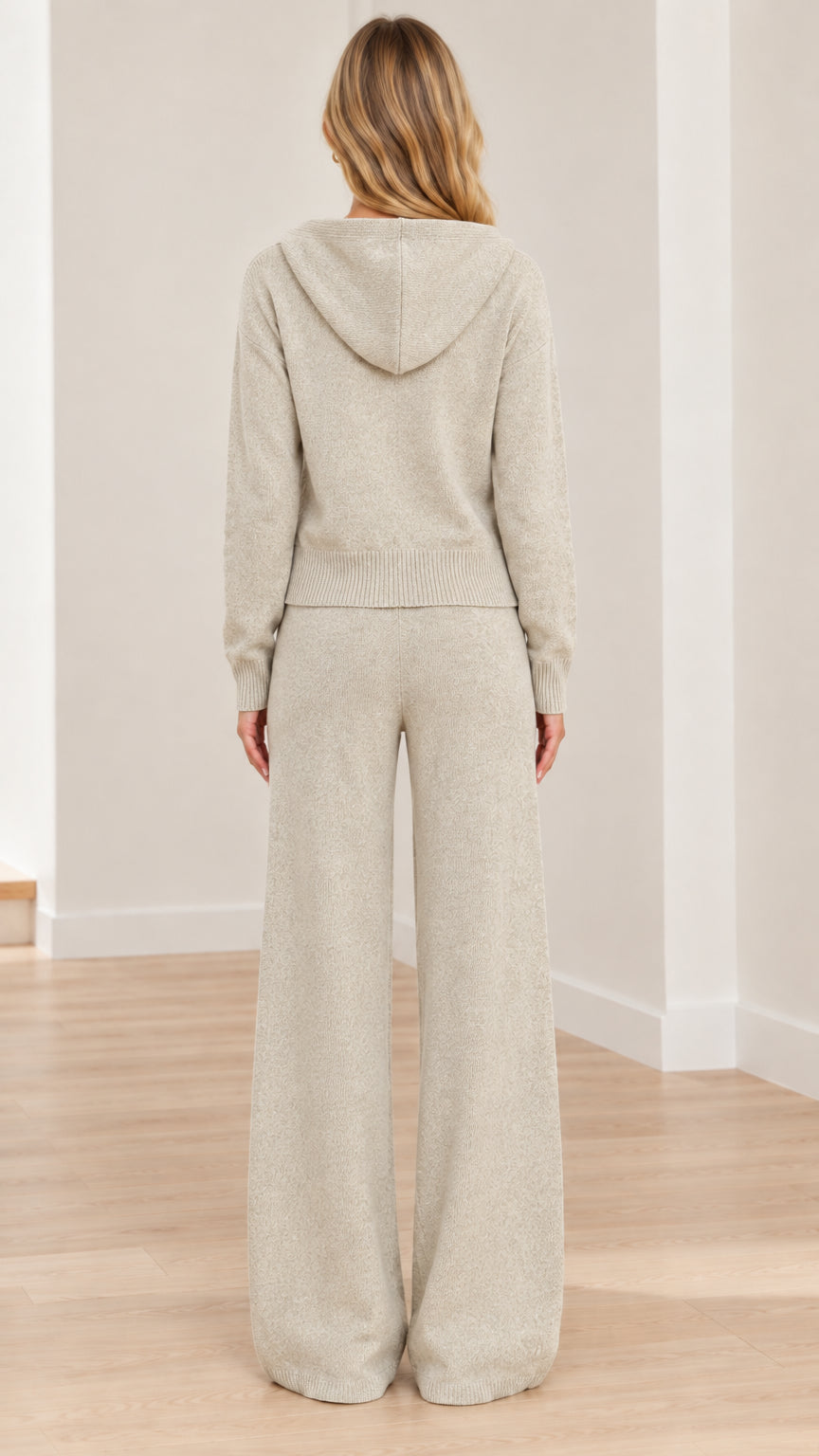 Rear view of model wearing Oatmeal hooded knit jacket and wide-leg trousers