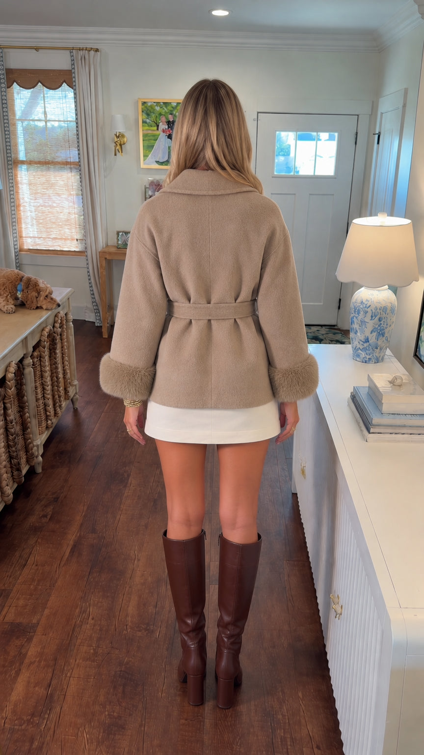 Back view of beige wrap coat showing belt tie and relaxed silhouette