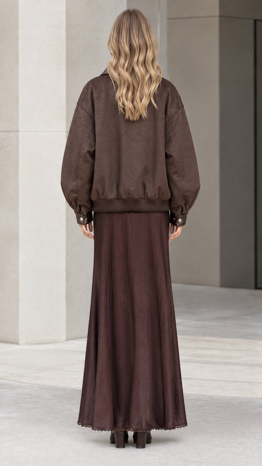 Back view of brown oversized bomber jacket and flowing maxi dress