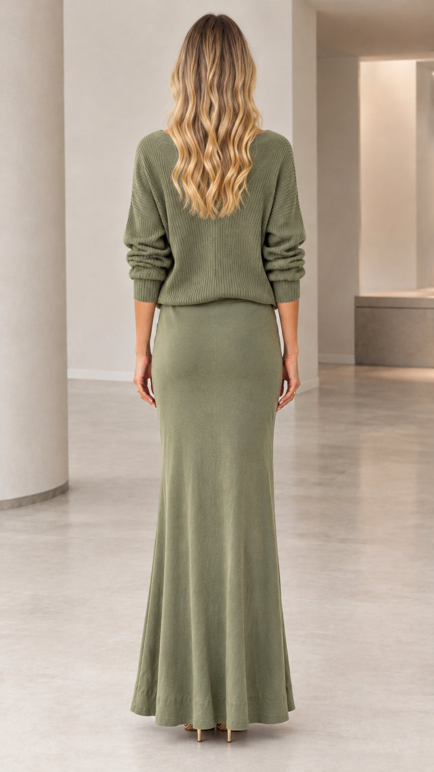 Back view of woman wearing sage green ribbed knit sweater and maxi skirt set