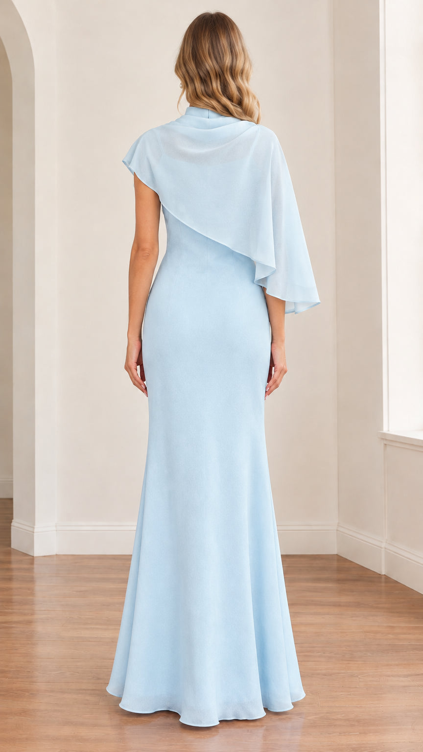 Back view of model wearing the light blue high-neck dress with draped cape overlay