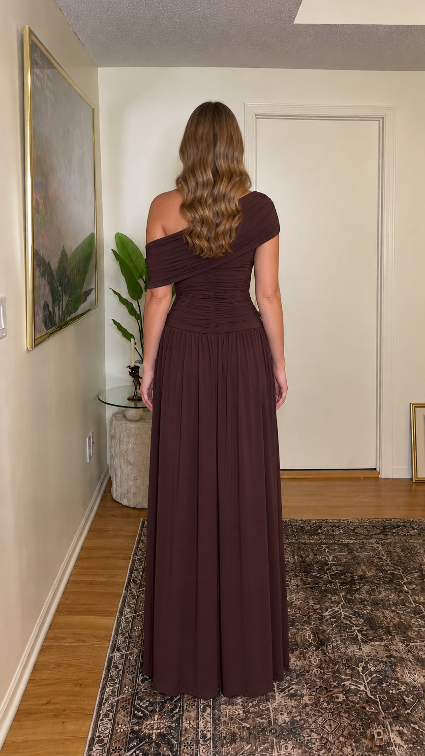Back full-length view of woman wearing chocolate brown one-shoulder ruched maxi dress