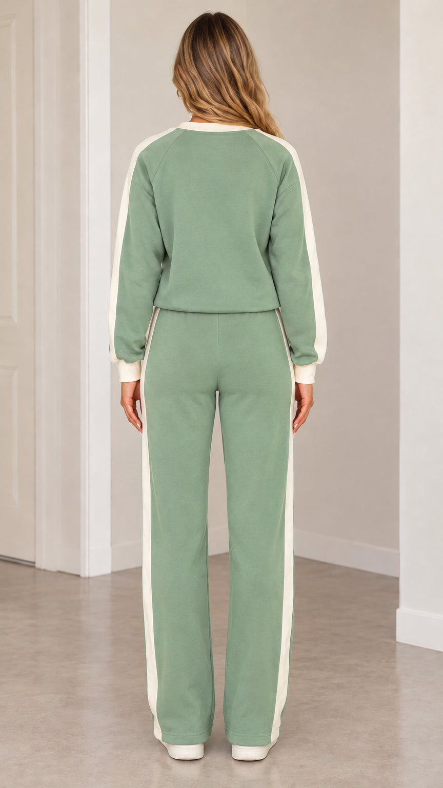 Back view of woman wearing sage green sweatshirt and wide leg pants tracksuit