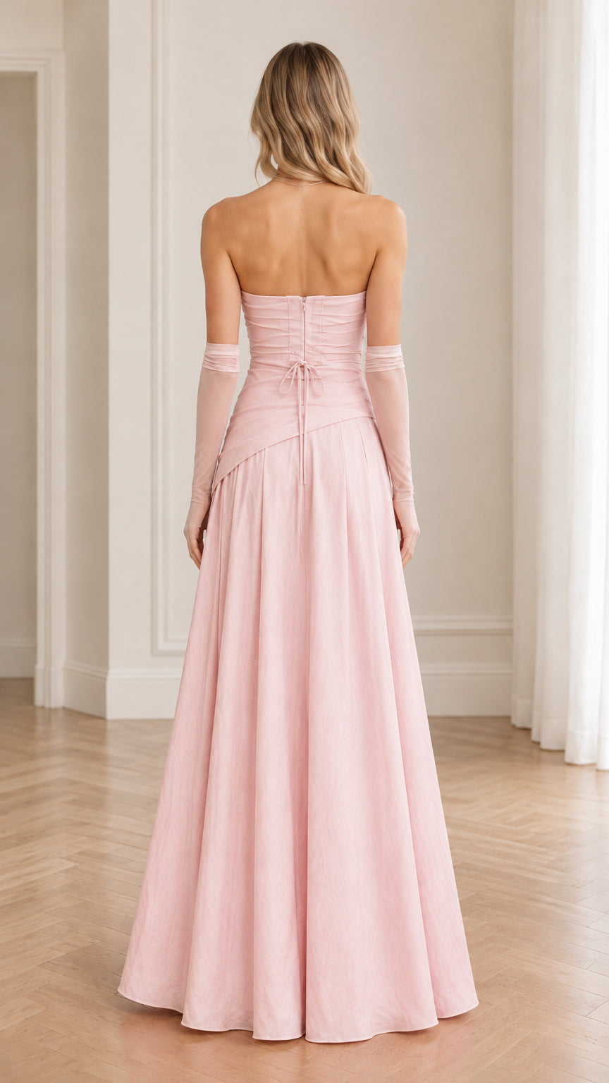 Back view of blush pink evening dress showcasing lace-up tie and zipper closure