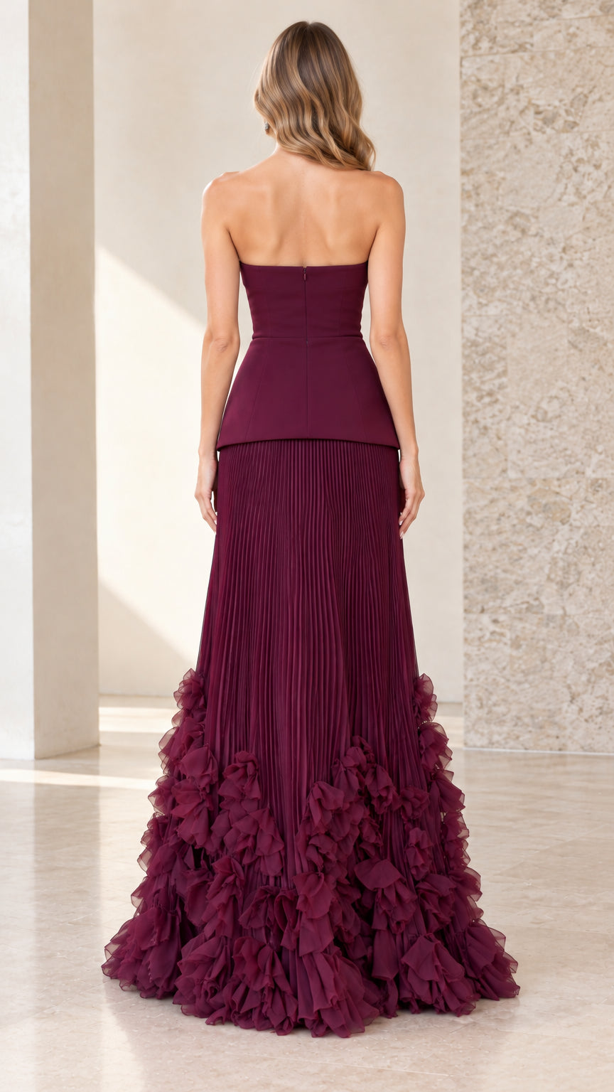 Back view of model wearing burgundy strapless peplum gown showing back zipper closure