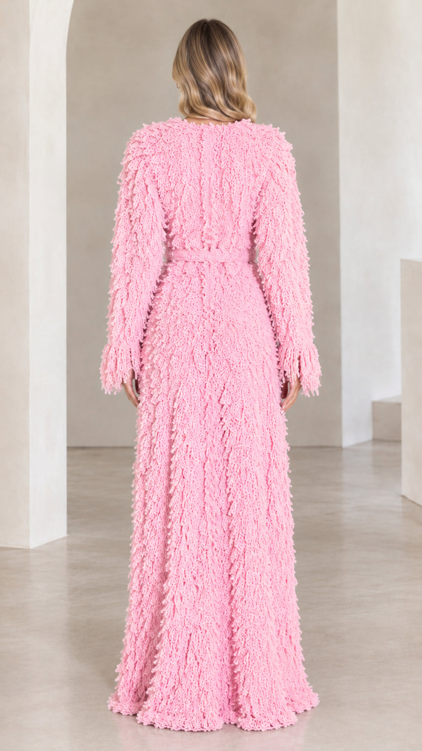 Back view of model wearing pink fringed maxi cardigan with tie belt detail
