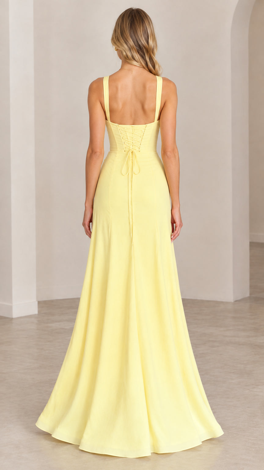 Back full-length view showing the lace-up corset and zipper detail on the yellow gown