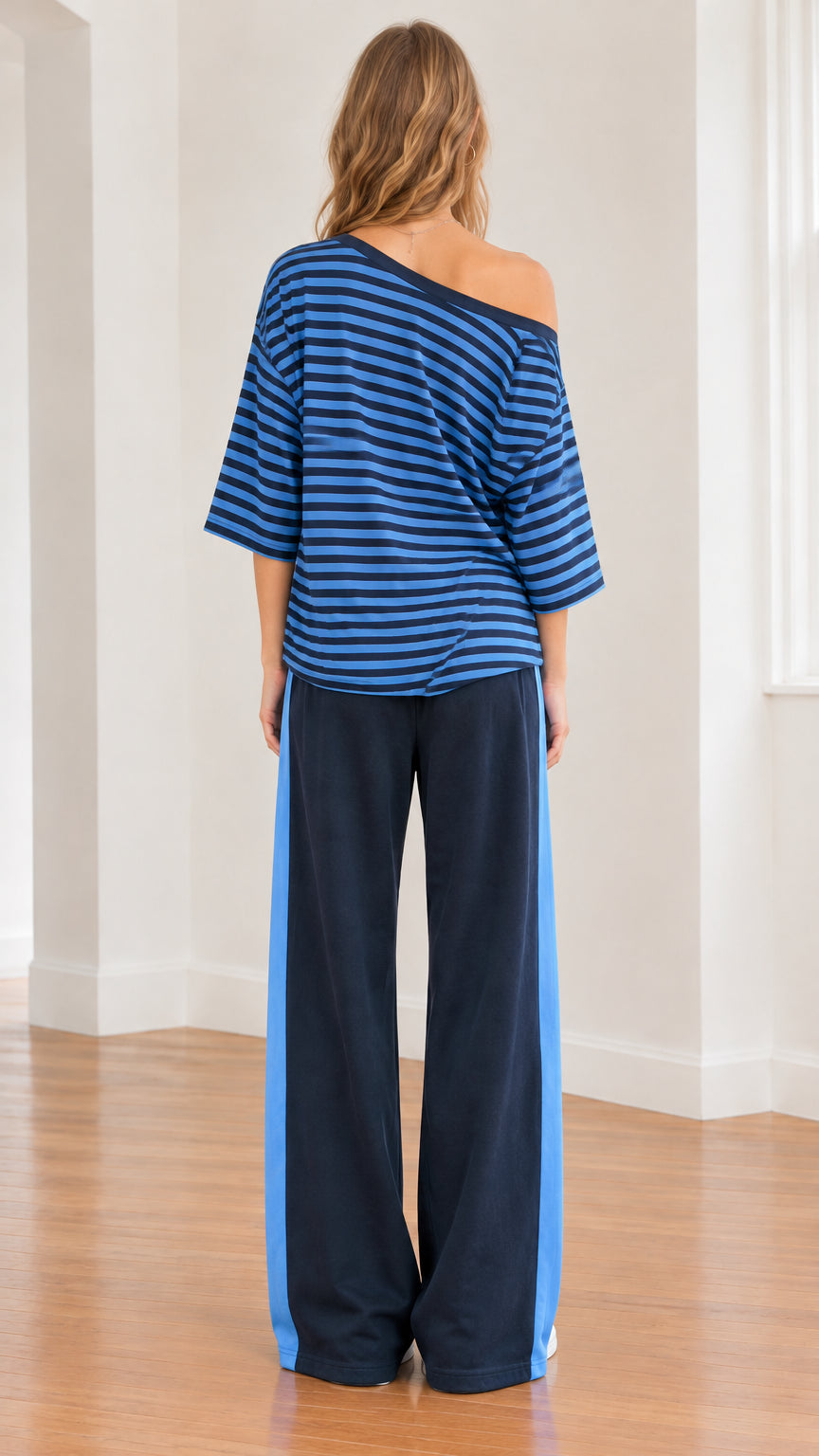 Back view of model wearing slouchy striped tee and navy wide-leg pants