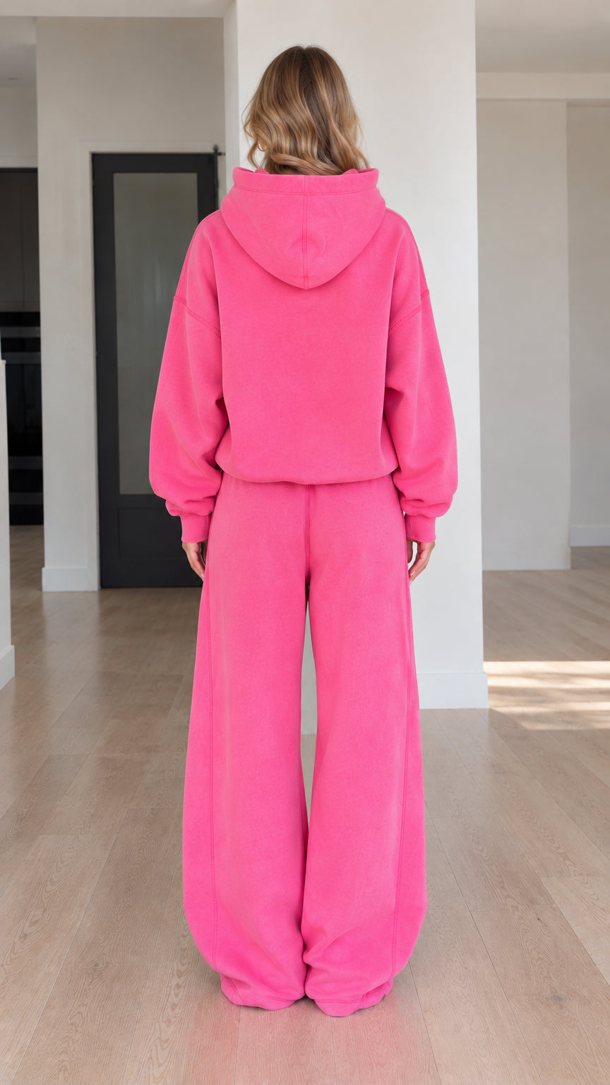 Back view of model wearing Fuchsia oversized hoodie and wide-leg sweatpants set